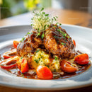 Gourmet Meat Dish with Mashed Potatoes and Tomatoes