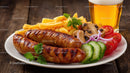 Grilled Sausages with Fries and Vegetables on Rustic Table