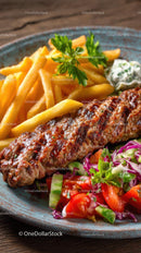 Grilled Kebab with Fries and Fresh Salad on a Rustic Plate