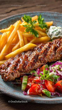 Grilled Kebab with Fries and Fresh Salad on a Rustic Plate