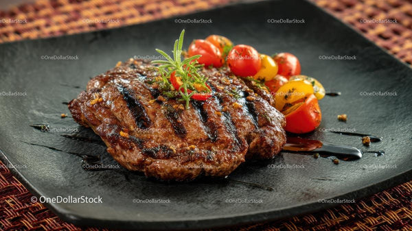 Grilled Steak with Cherry Tomatoes and Rosemary Garnish