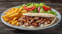 Shawarma and Fries with Fresh Salad on a Wooden Table