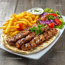 Grilled Meat Skewers with Fries and Fresh Salad on a Plate