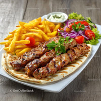 Grilled Meat Skewers with Fries and Fresh Salad on a Plate