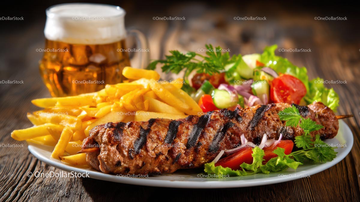 Grilled Skewer with Fries and Fresh Salad on Rustic Table
