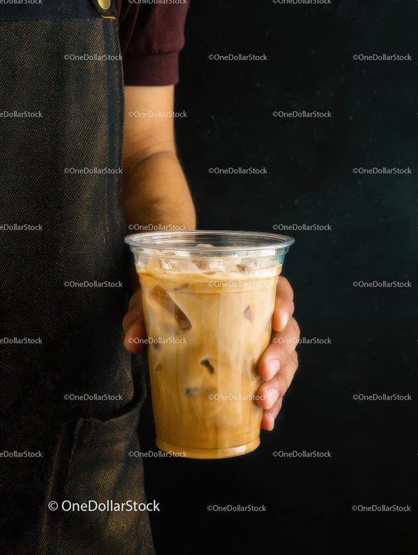 Barista Hand Holding Iced Coffee in Plastic Cup