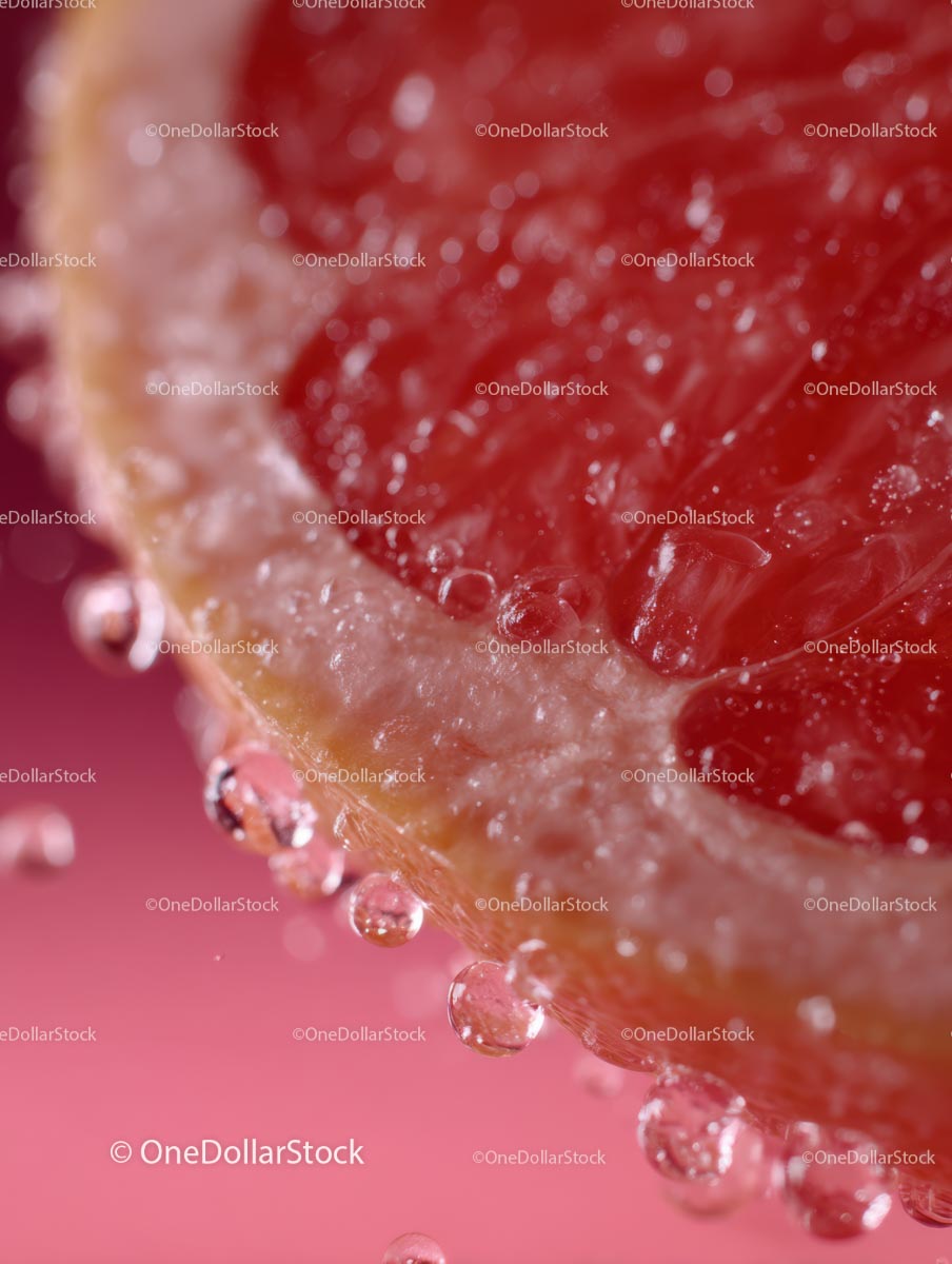 Macro Shot of Juicy Grapefruit Slice with Water Droplets