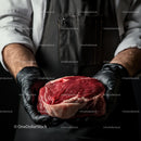 Butcher Holding Fresh Ribeye Steak