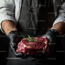 Chef Holding Fresh Raw Beef Steak with Rosemary Garnish
