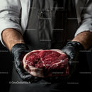 Chef Holding Fresh Marbled Ribeye Steak