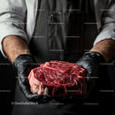Chef Holding Premium Cut of Raw Marbled Beef
