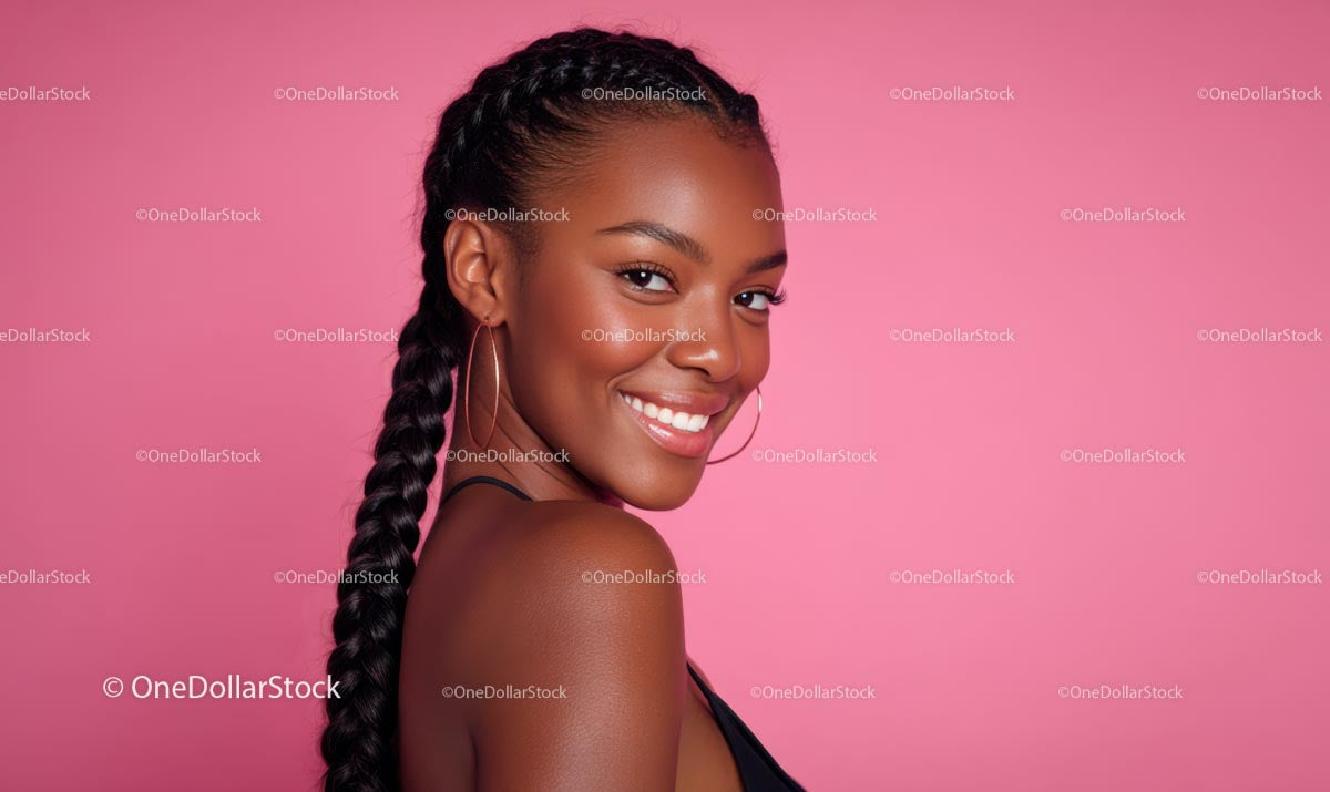Smiling Girl with Plaits on a Soft Pink Backdrop