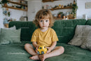 Adorable Child with Toy Car in Cozy Living Room
