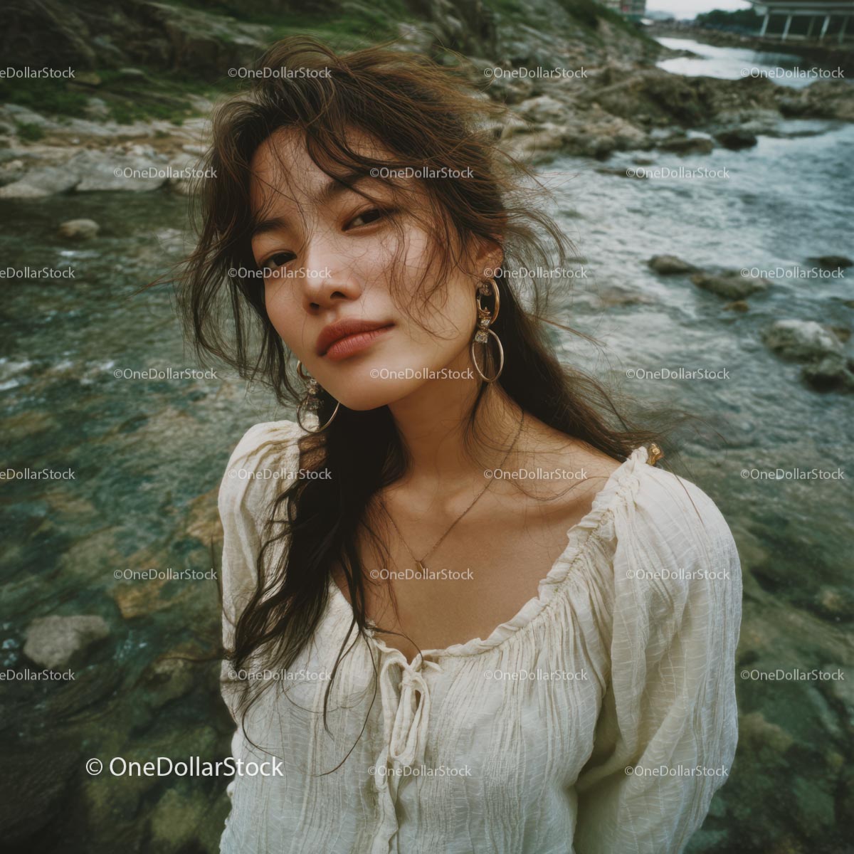 Bohemian Woman Posing by a Tranquil Rocky Shore