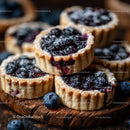 Homemade Blueberry Tarts on Rustic Wooden Board