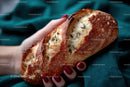 Hand Holding Crusty Artisan Bread with Rosemary