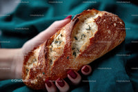 Hand Holding Crusty Artisan Bread with Rosemary