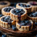 Homemade Blueberry Tarts on Rustic Wooden Board