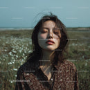 Serene Woman Posing in a Field of Wildflowers
