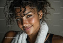 Smiling Woman with Curly Hair and Fitness Towel