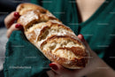 Crusty Artisan Baguette in Hands with Red Nails