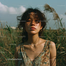Young Woman in Floral Dress Surrounded by Tall Grass