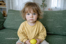 Adorable Toddler in Yellow on Green Sofa