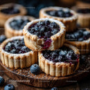 Homemade Blueberry Tarts on Rustic Wooden Board