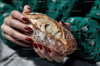 Freshly Baked Artisan Bread Held in Hands
