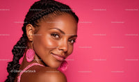 Smiling Woman with Braided Hair and Pink Accessories
