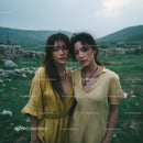 Two Women in Yellow Dresses in Countryside