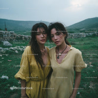 Two Women in Yellow Dresses in Countryside