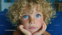 Portrait of a Child with Curly Blonde Hair and Blue Eyes