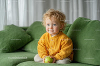 Adorable Toddler with Curly Hair Holding Green Apple