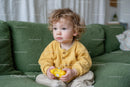 Curly-Haired Toddler Playing with Video Game Controller