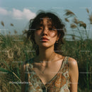 Young Woman Enjoying a Serene Moment in a Grassy Field