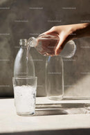 Pouring Water into a Glass with Sunlit Reflections