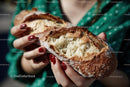 Woman Holding Freshly Baked Rustic Baguette