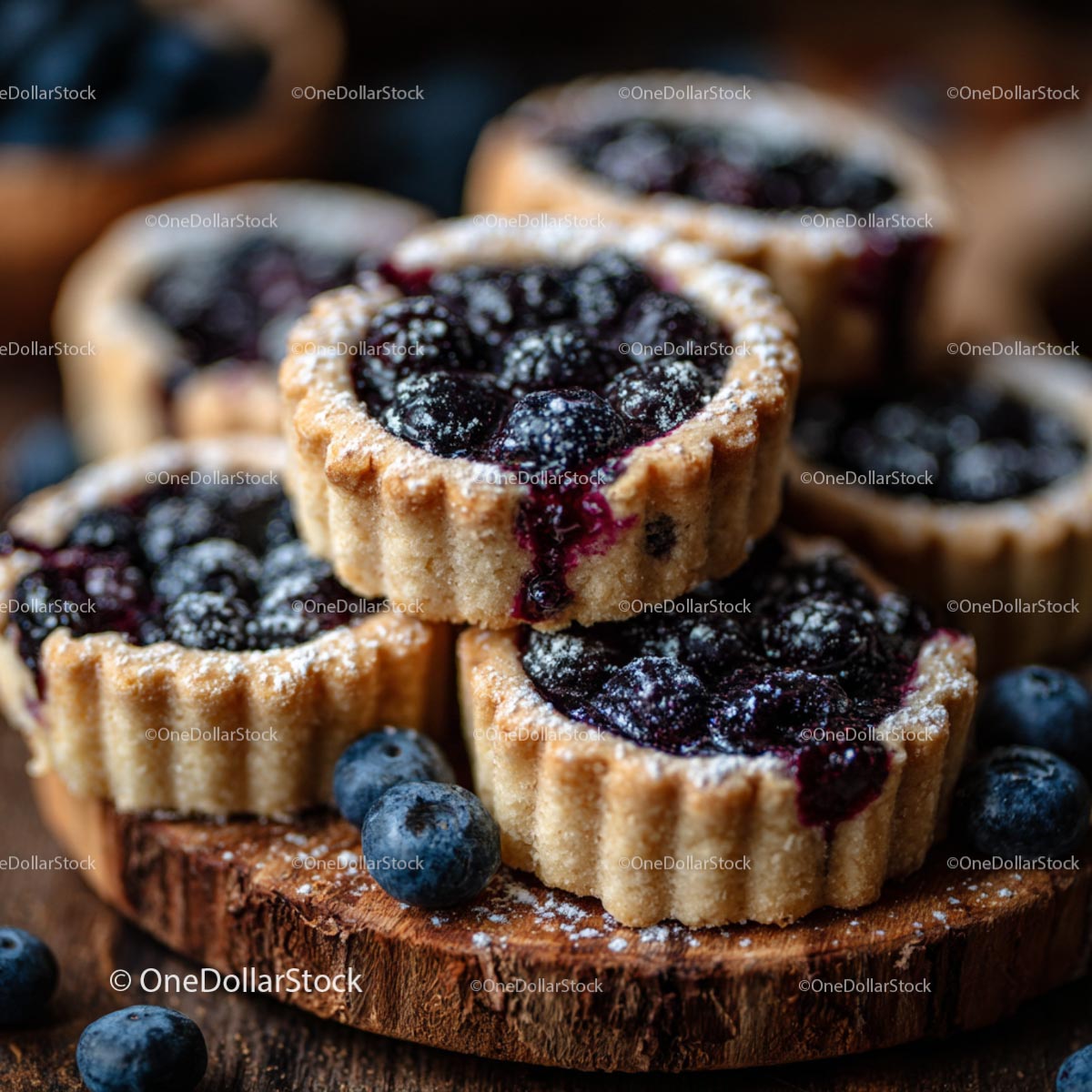 Rustic Blueberry Tarts with Powdered Sugar on Wooden Board