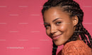 Smiling Woman with Braided Hair on Pink Background