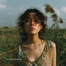 Woman Standing in a Field with Windswept Hair