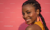 Smiling Woman with Braided Hair Against Pink Background