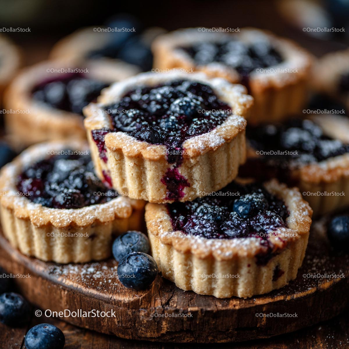 Rustic Blueberry Tarts with Powdered Sugar on Wooden Board