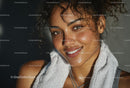Smiling Woman with Curly Hair and Towel in Sunlight