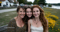 Smiling Family in Scenic Park with Yellow Flowers