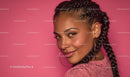 Smiling Woman with Braided Hair on Pink Background