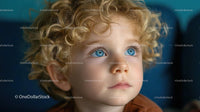 Curly-Haired Blonde Toddler with Bright Blue Eyes