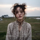 Bohemian Woman in Serene Countryside Landscape
