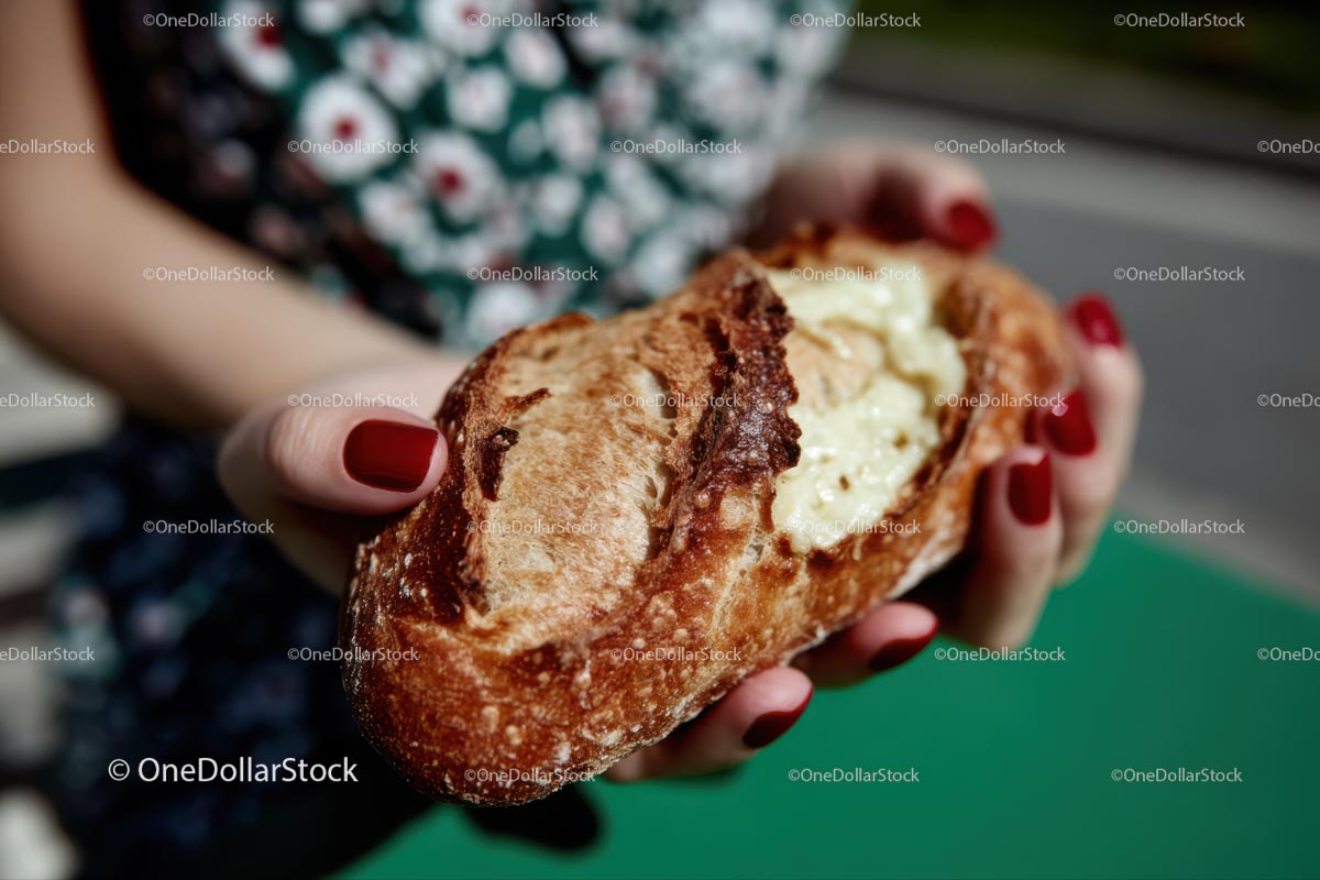 Hands Holding Artisan Bread with Melted Cheese