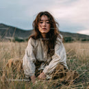 Young Woman in Bohemian Attire in Serene Landscape